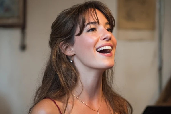 young woman singing, happy, long brown hair